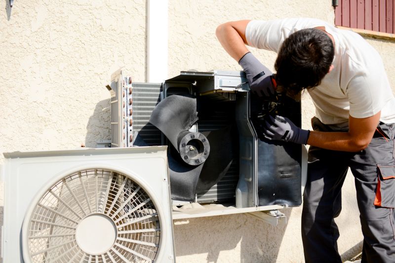 Technician Repairing a Window Ac